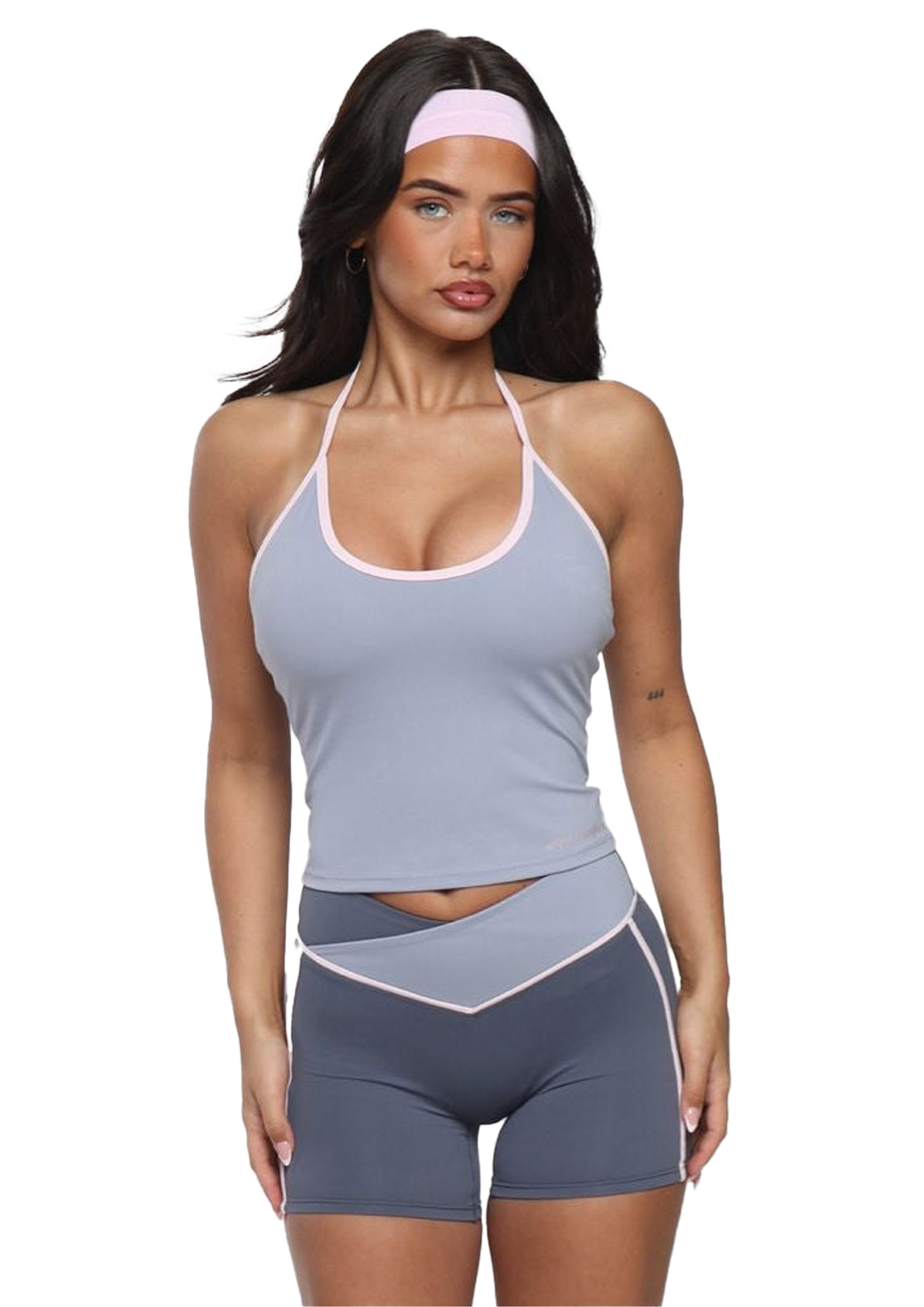 Woman wearing a gray athletic outfit with a white background