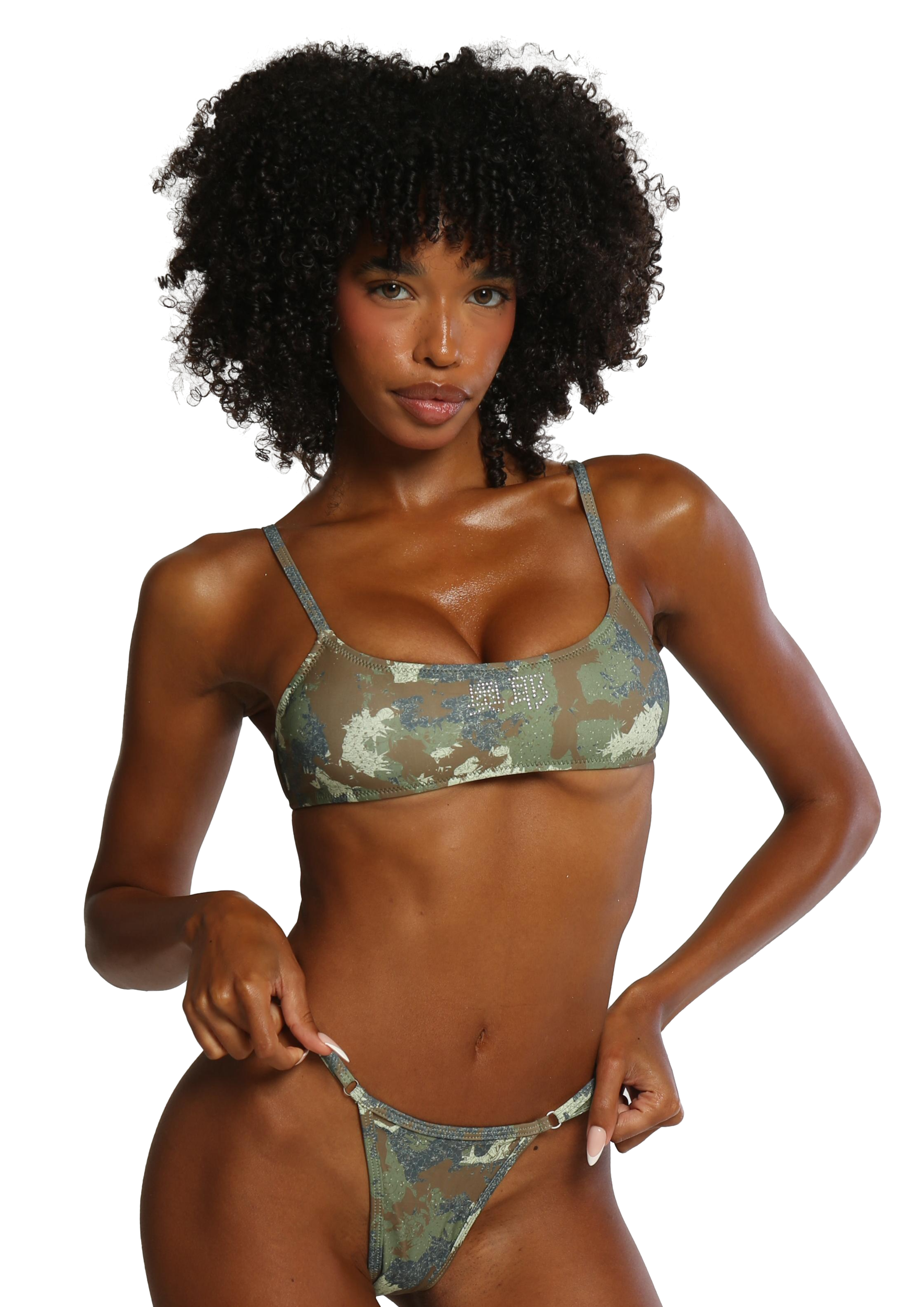 Woman wearing a camouflage bikini on a white background