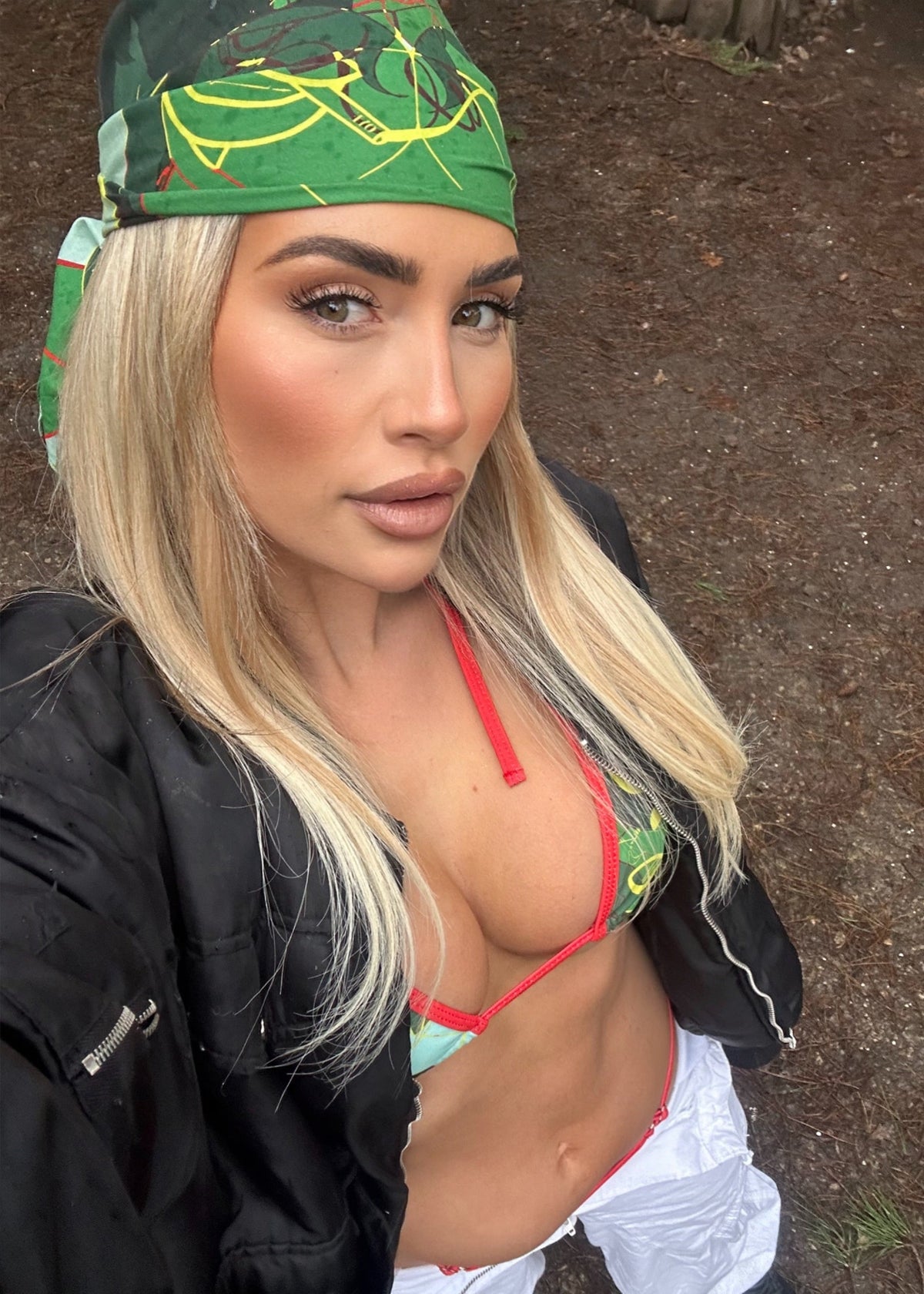 Woman wearing a green headscarf with leaf patterns outdoors