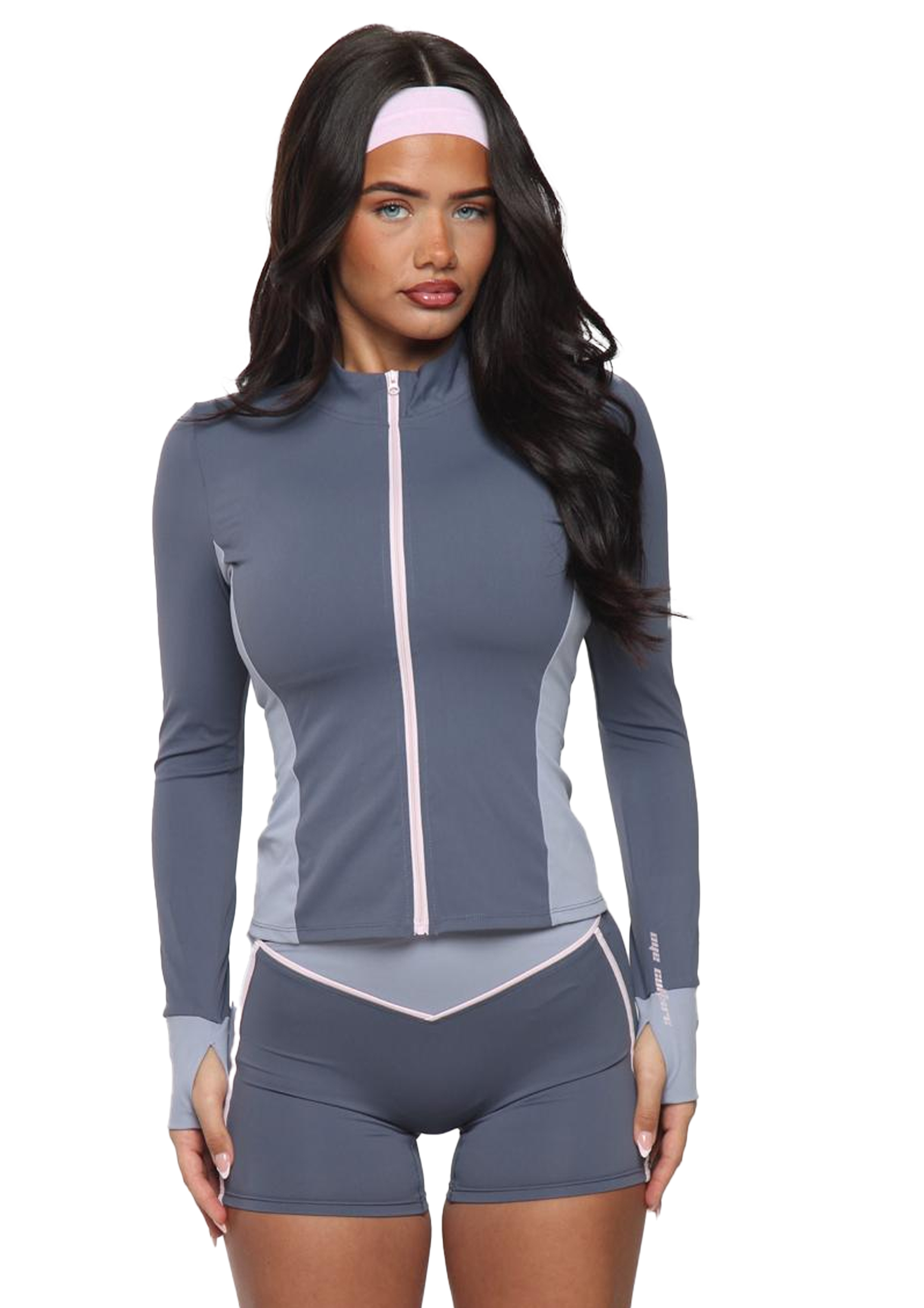 Woman wearing a gray athletic outfit with a white background