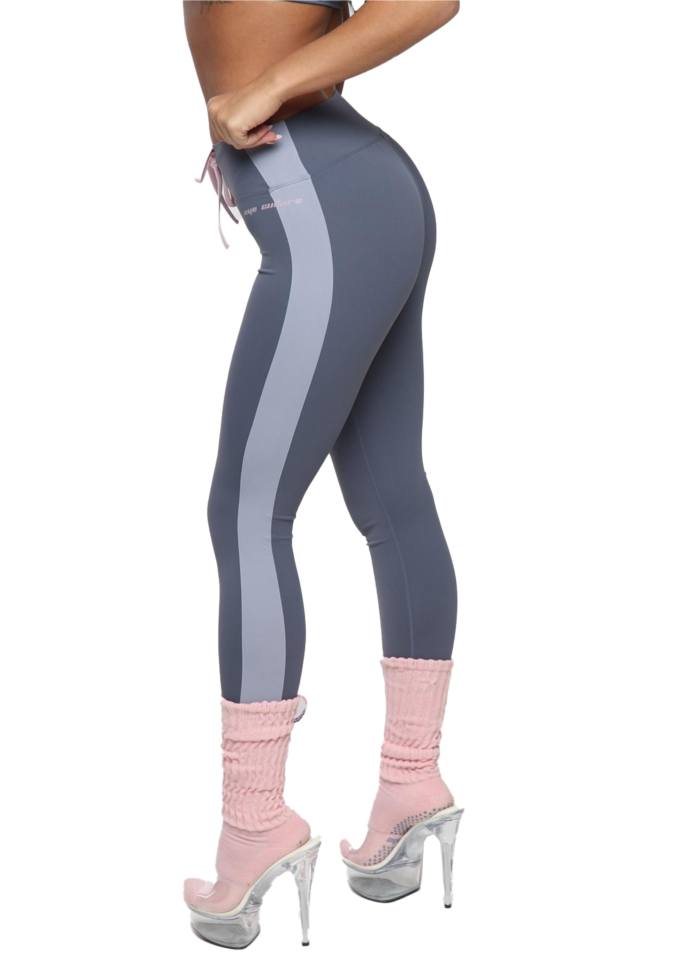 Gray leggings with a stripe pattern worn by a person on a white background